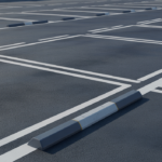 Modern, well-maintained commercial parking lot featuring clear markings, speed bumps, and bollards, highlighting safety and efficiency.