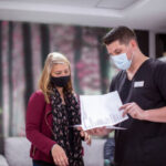 Patient reviewing itemized dental treatment plan with office coordinator at Aspen Dental clinic