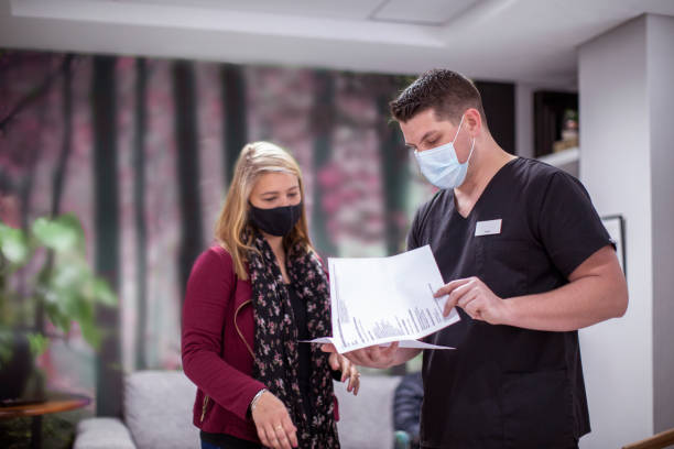 Patient reviewing itemized dental treatment plan with office coordinator at Aspen Dental clinic