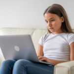 Teenage girl engaging in telehealth counseling session at home, representing teen telehealth counseling in Queens